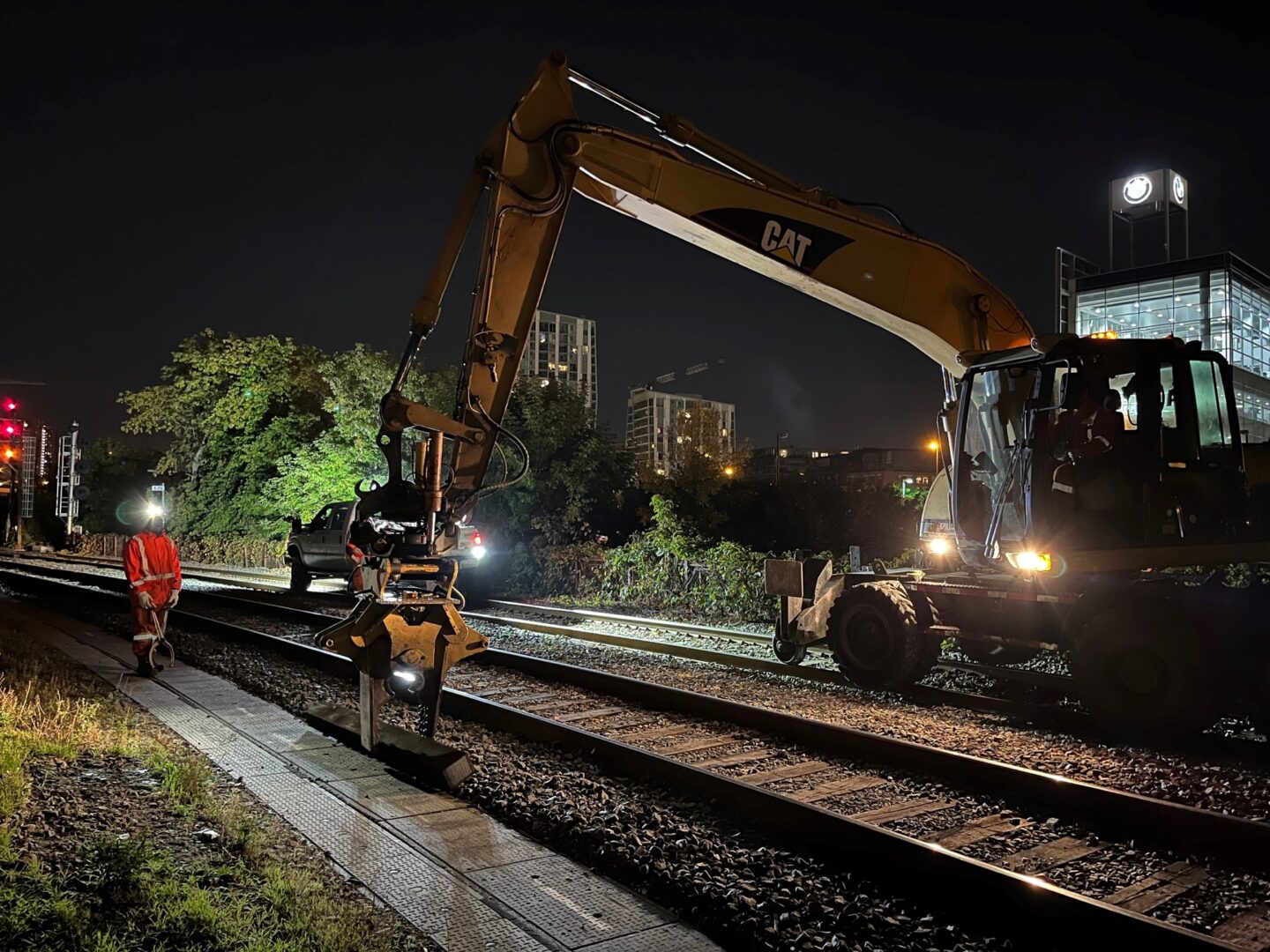 Excavator working on a railway at night